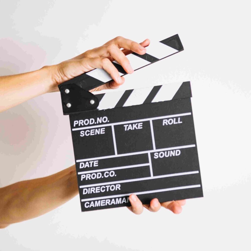 person clapping clapperboard